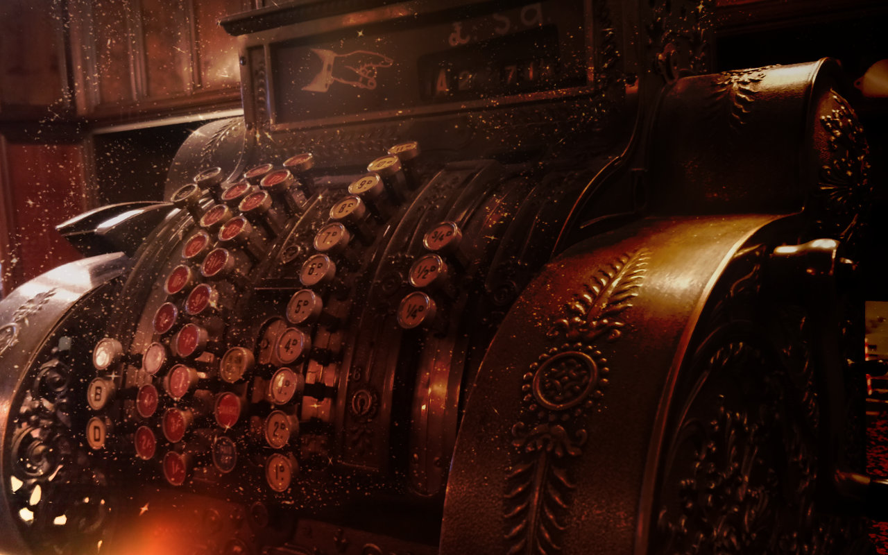 Antique vintage cash register with ornate metalwork, antique keys, and warm lighting.