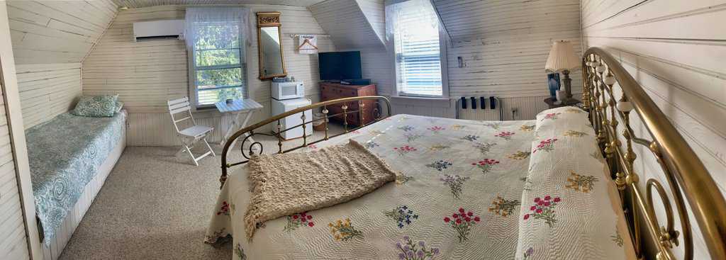 Cozy mountain cottage bedroom with vintage decor and rustic charm at Mountain Harbour.